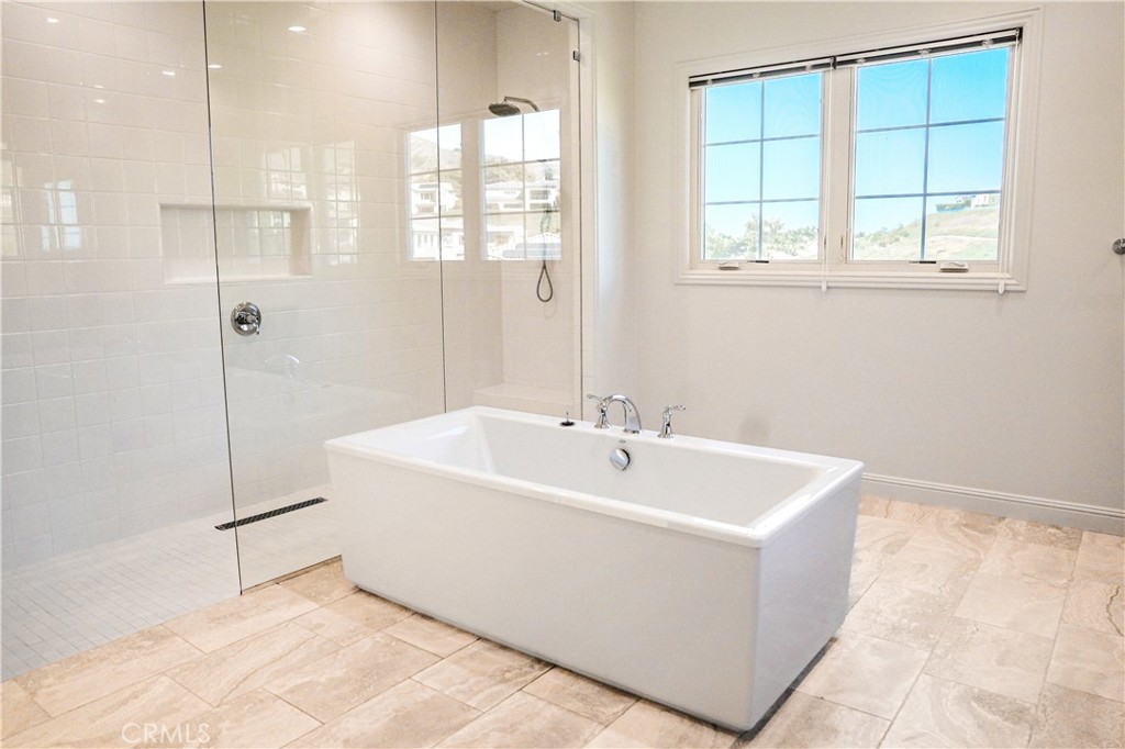 111 Lanzon Irvine, CA 92602 - Photo 24 of 42 a spacious bathroom with a bathtub and shower