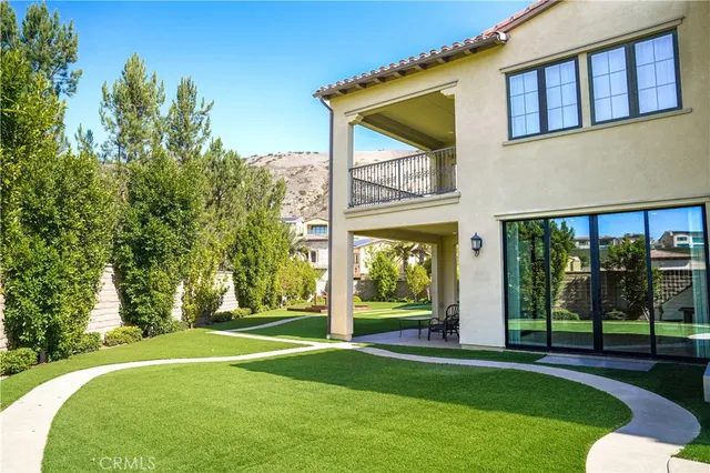 a view of a house with a backyard and a patio