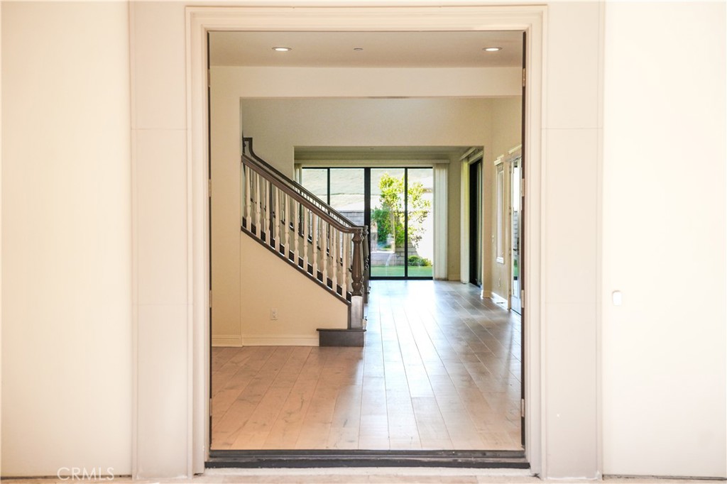 111 Lanzon Irvine, CA 92602 - Photo 4 of 42 a view of a hallway with wooden floor and staircase