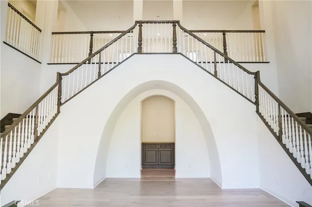 a view of entryway with wooden floor and stairs