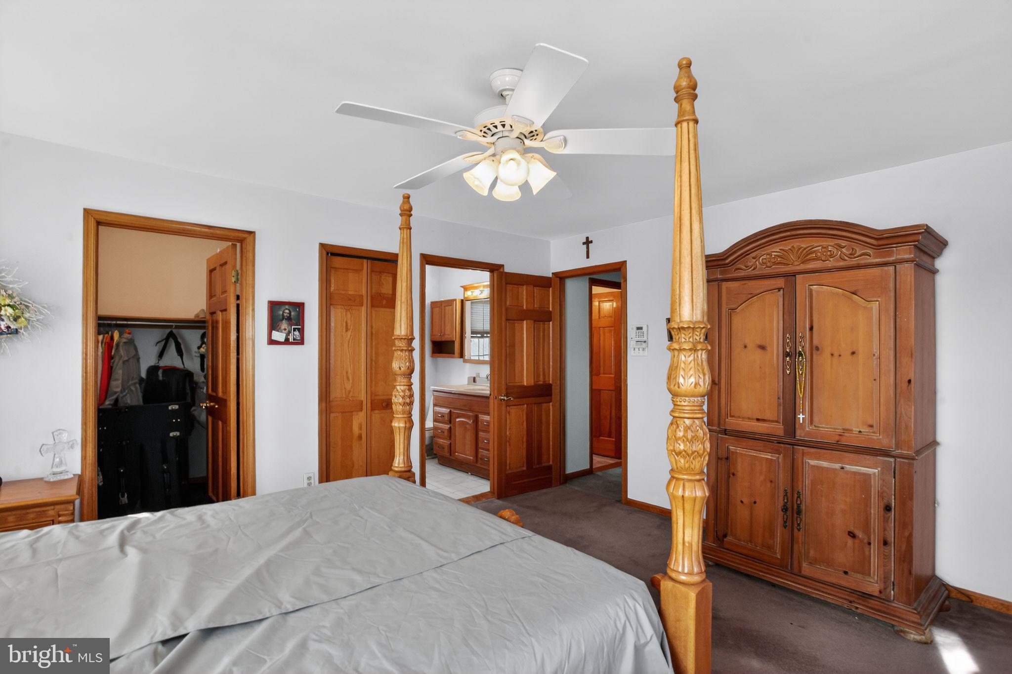 4508 Benson Street Philadelphia, PA 19136 - Photo 16 of 26 a bedroom with a bed and a chandelier