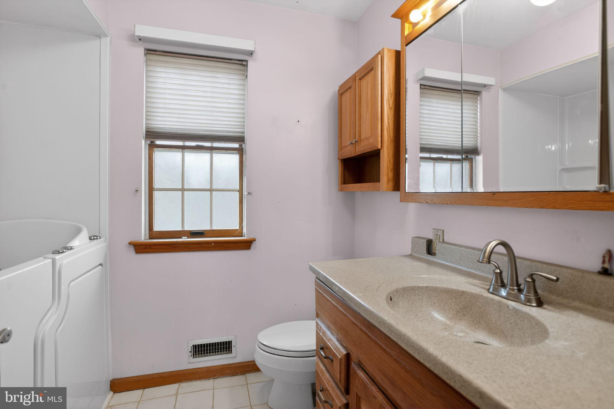 4508 Benson Street Philadelphia, PA 19136 - Photo 17 of 26 a bathroom with a toilet sink and mirror