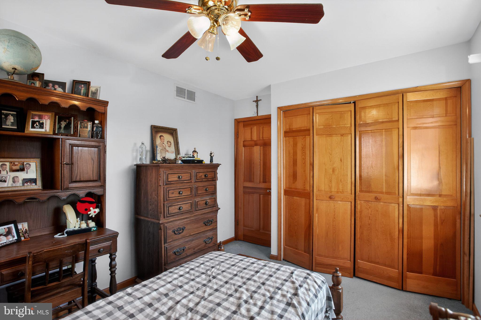 4508 Benson Street Philadelphia, PA 19136 - Photo 21 of 26 a bedroom with a dresser and a chandelier