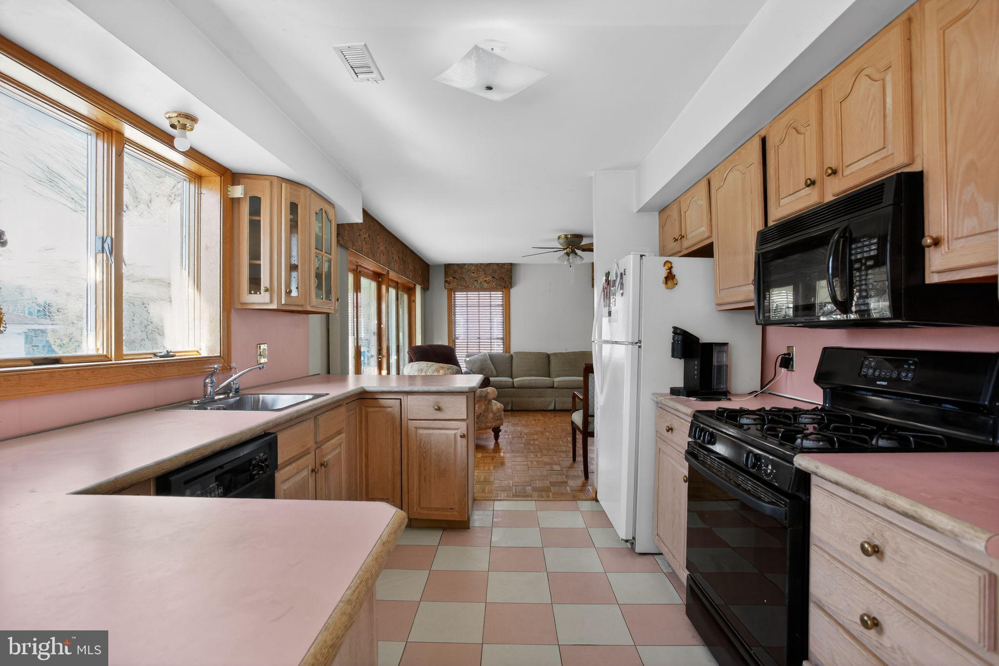 4508 Benson Street Philadelphia, PA 19136 - Photo 9 of 26 a kitchen with stainless steel appliances a stove sink microwave and cabinets