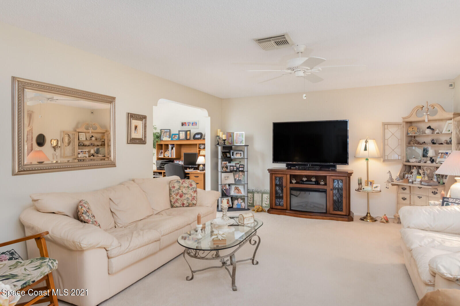 1953 Trimble Road Melbourne, FL 32934 - Photo 12 of 70 a living room with furniture and a flat screen tv