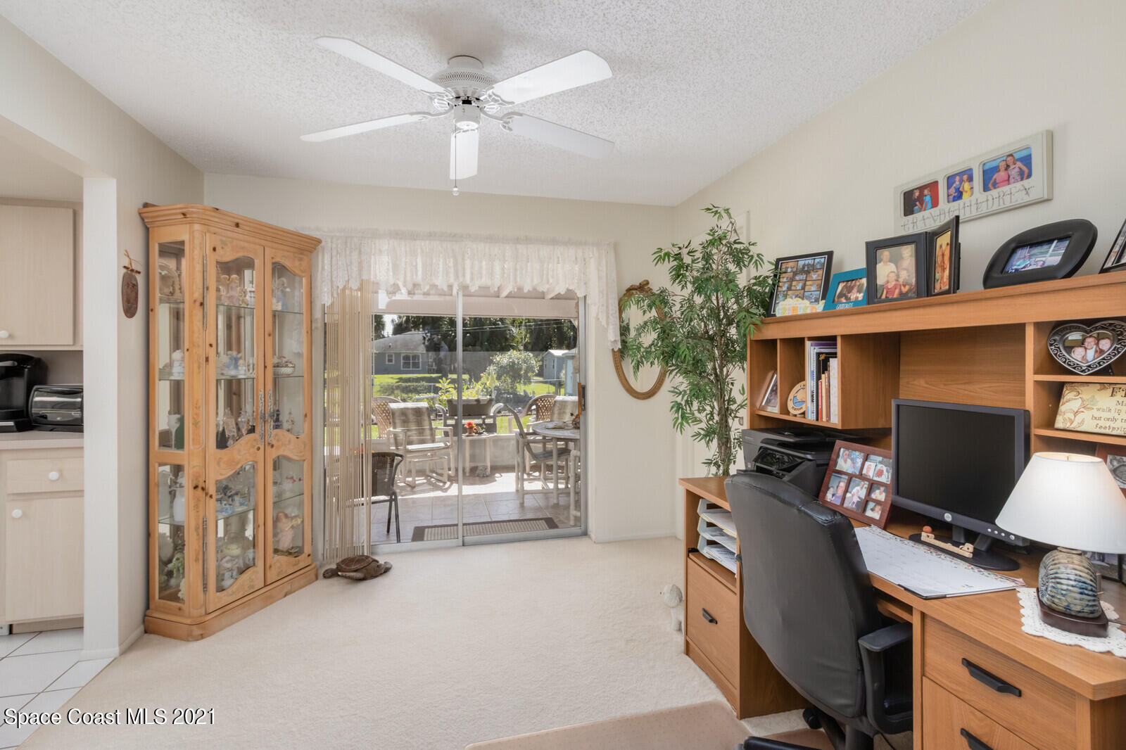 1953 Trimble Road Melbourne, FL 32934 - Photo 15 of 70 a view of a workspace with furniture and a window