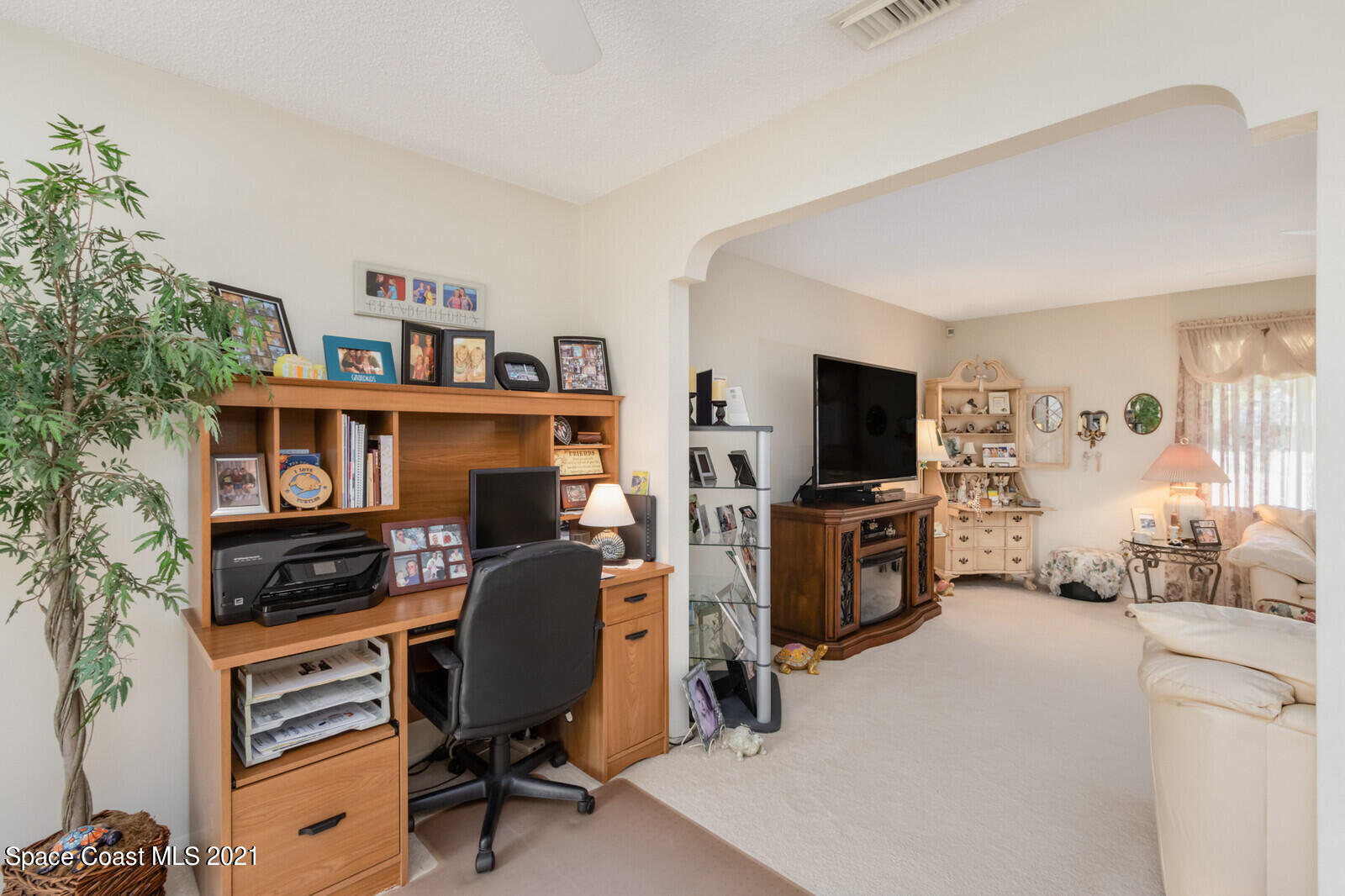 1953 Trimble Road Melbourne, FL 32934 - Photo 16 of 70 a workspace with furniture cabinet and a window