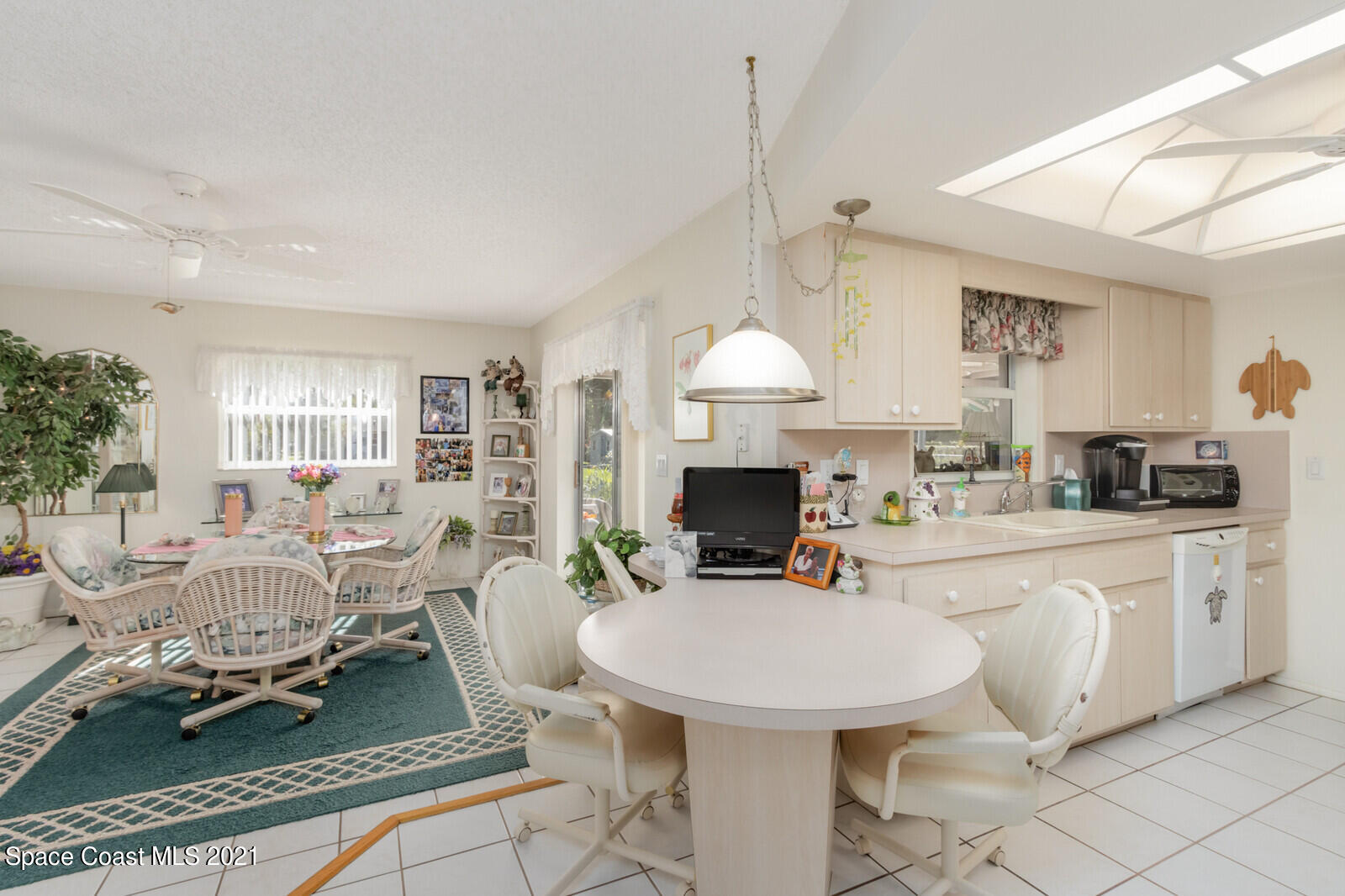 1953 Trimble Road Melbourne, FL 32934 - Photo 19 of 70 a living room with furniture a fireplace and a chandelier