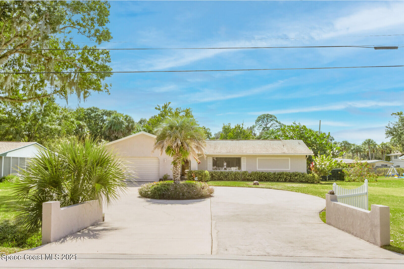 1953 Trimble Road Melbourne, FL 32934 - Photo 3 of 70 a front view of a house with a yard and potted plants