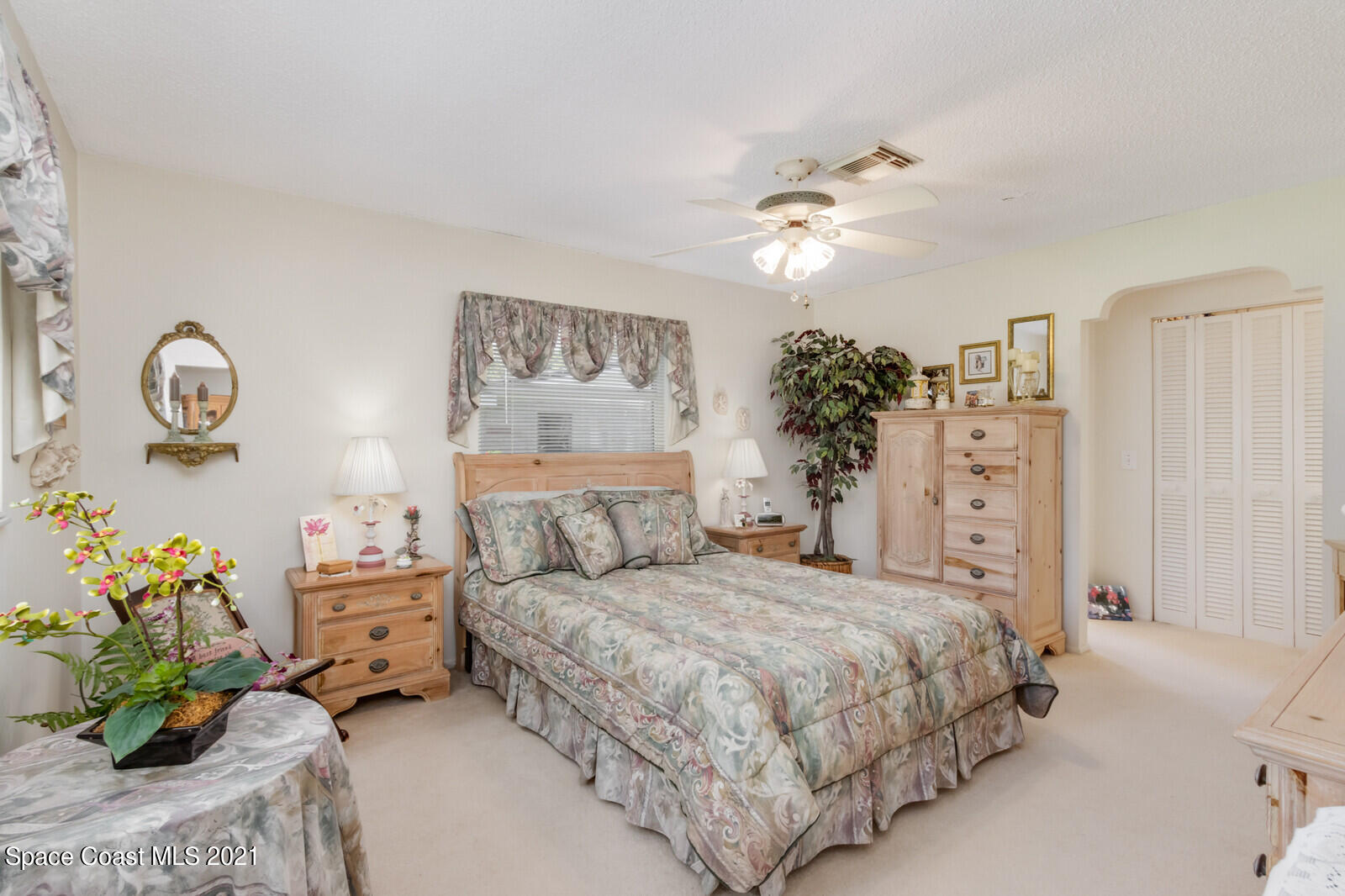 1953 Trimble Road Melbourne, FL 32934 - Photo 25 of 70 a bedroom with a bed and a chandelier