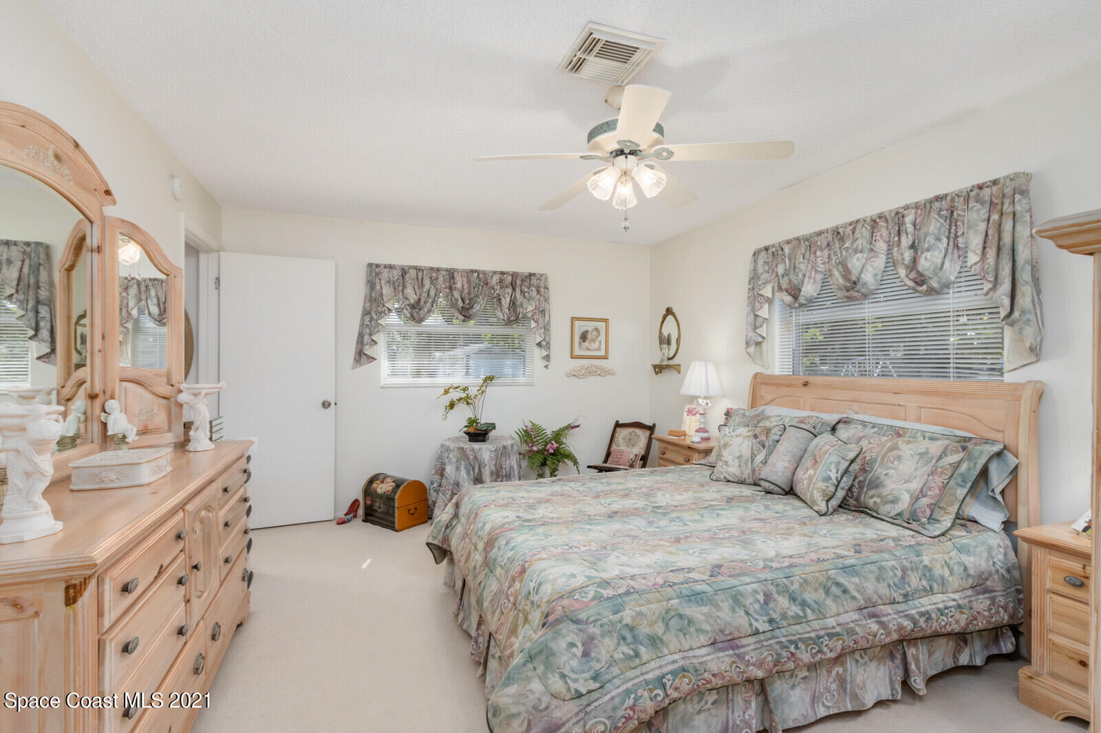 1953 Trimble Road Melbourne, FL 32934 - Photo 26 of 70 a bedroom with double bed and a chandelier