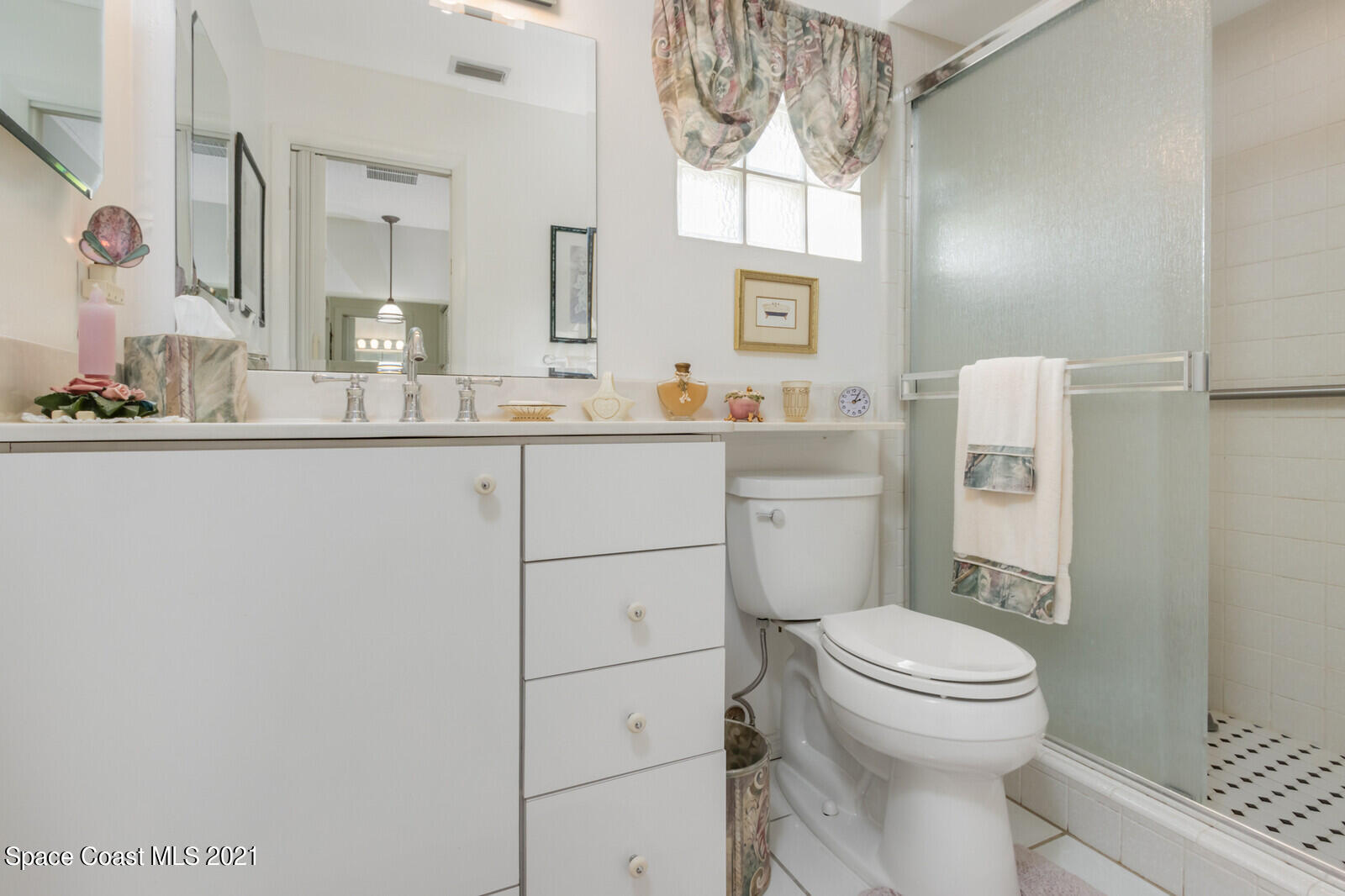 1953 Trimble Road Melbourne, FL 32934 - Photo 28 of 70 a bathroom with a granite countertop toilet sink and mirror