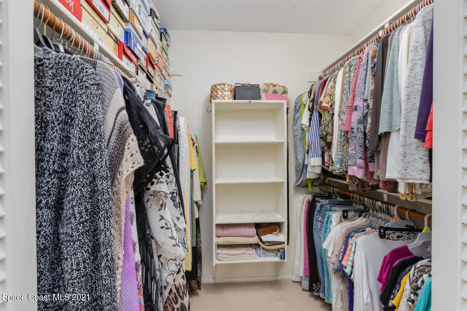 1953 Trimble Road Melbourne, FL 32934 - Photo 30 of 70 a view of walk in closet with clothes and shoes