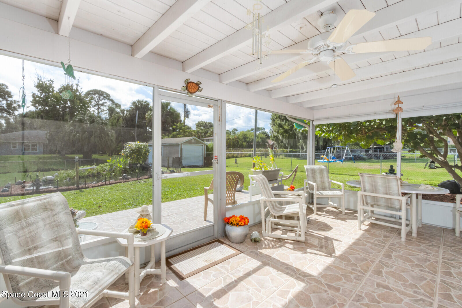 1953 Trimble Road Melbourne, FL 32934 - Photo 33 of 70 a view of a patio with a table chairs and a backyard