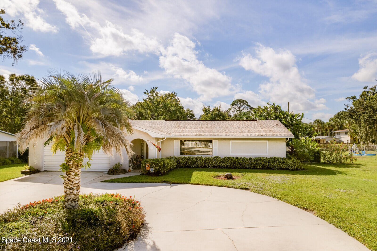 1953 Trimble Road Melbourne, FL 32934 - Photo 35 of 70 a view of swimming pool with outdoor seating and trees in the background
