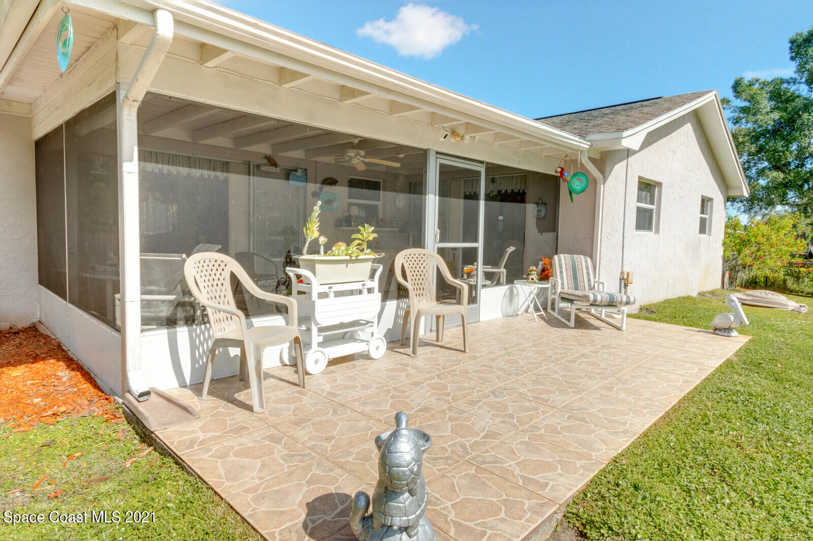1953 Trimble Road Melbourne, FL 32934 - Photo 8 of 70 a view of a patio with table and chairs and potted plants