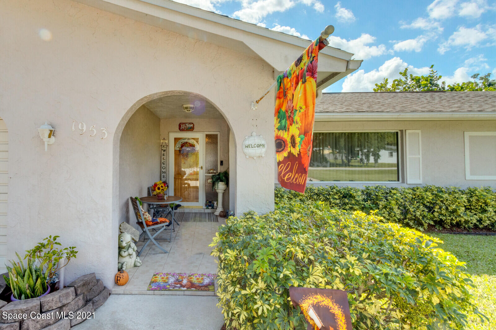 1953 Trimble Road Melbourne, FL 32934 - Photo 9 of 70 a front view of a house with lots of yellow lighting