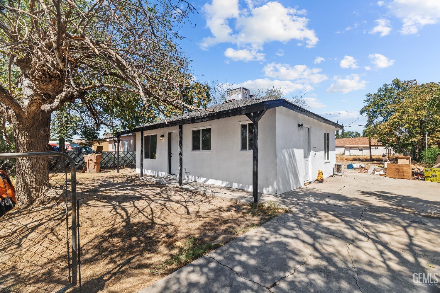 a view of a house with snow on the side of the road
