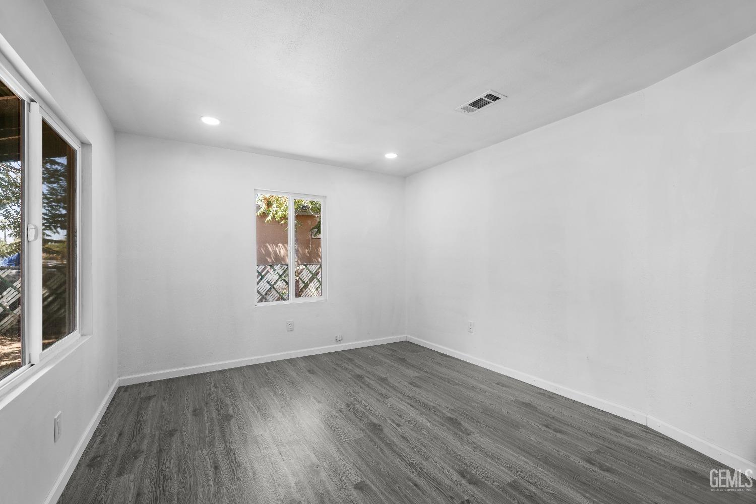 Undisclosed Address Bakersfield, CA 93307 - Photo 13 of 15 wooden floor in an empty room with a window
