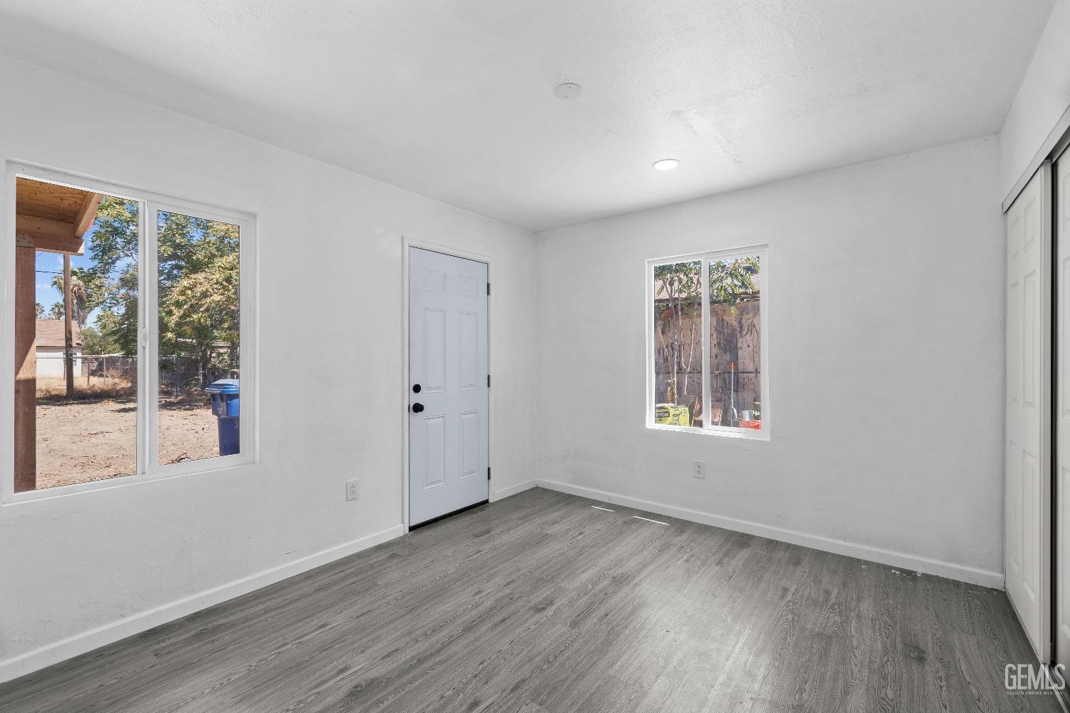 Undisclosed Address Bakersfield, CA 93307 - Photo 4 of 15 a view of an empty room with wooden floor and a window