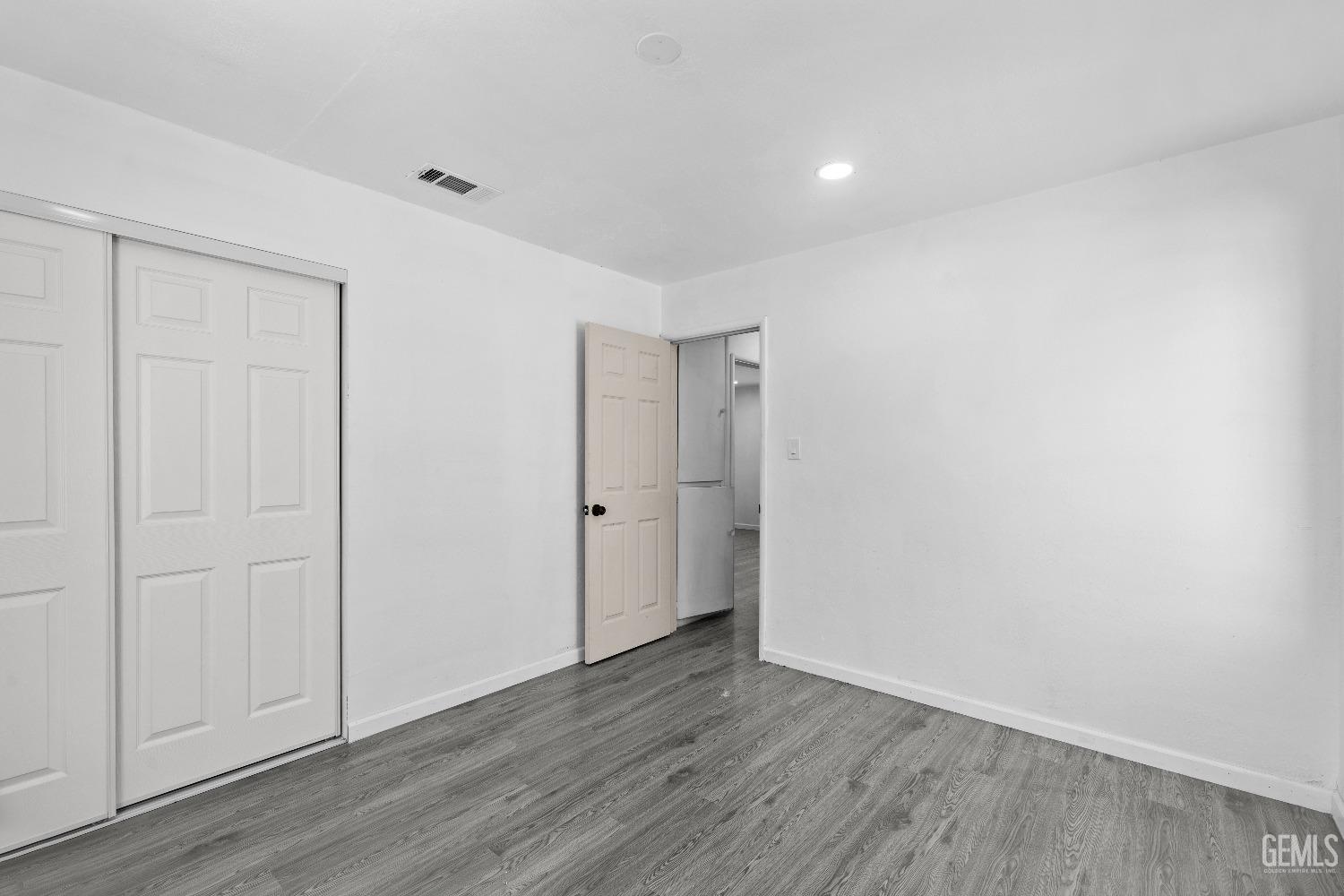 Undisclosed Address Bakersfield, CA 93307 - Photo 5 of 15 a view of an empty room with closet and wooden floor