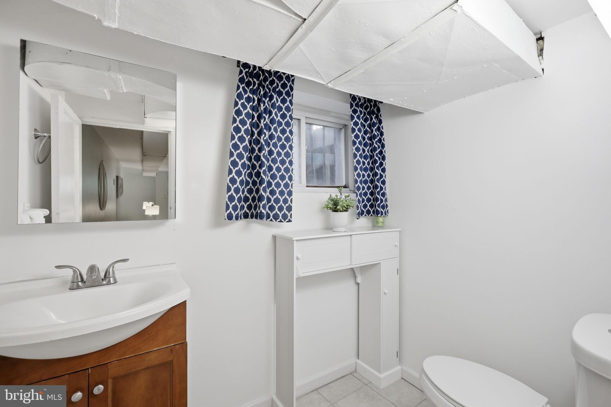 1020 10th Street Northeast Washington, DC 20002 - Photo 20 of 36 a bathroom with a sink toilet and mirror