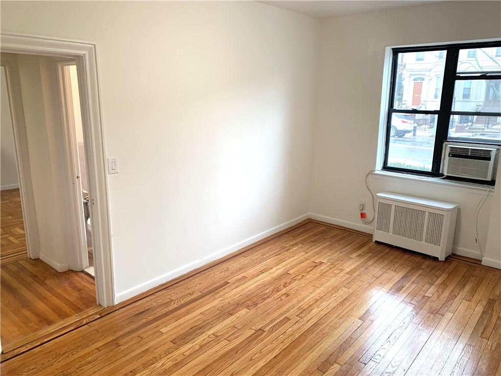 402 Bay Ridge Parkway, Unit 5 Brooklyn, NY 11209 - Photo 14 of 14 an empty room with wooden floor and windows