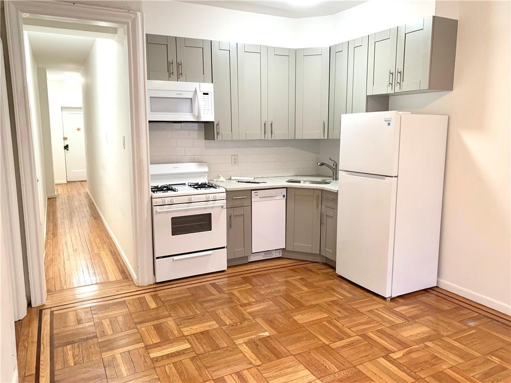 402 Bay Ridge Parkway, Unit 5 Brooklyn, NY 11209 - Photo 4 of 14 a kitchen with cabinets and white appliances