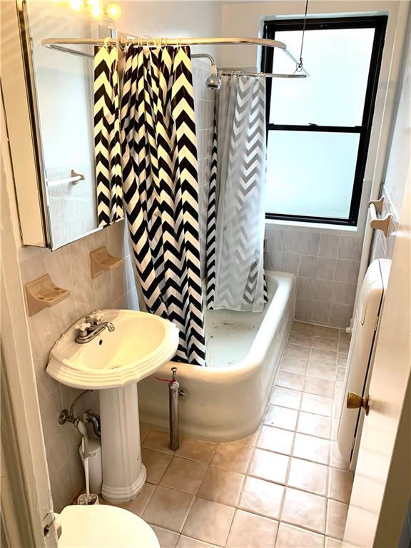 402 Bay Ridge Parkway, Unit 5 Brooklyn, NY 11209 - Photo 9 of 14 a bathroom with a sink a toilet and mirror