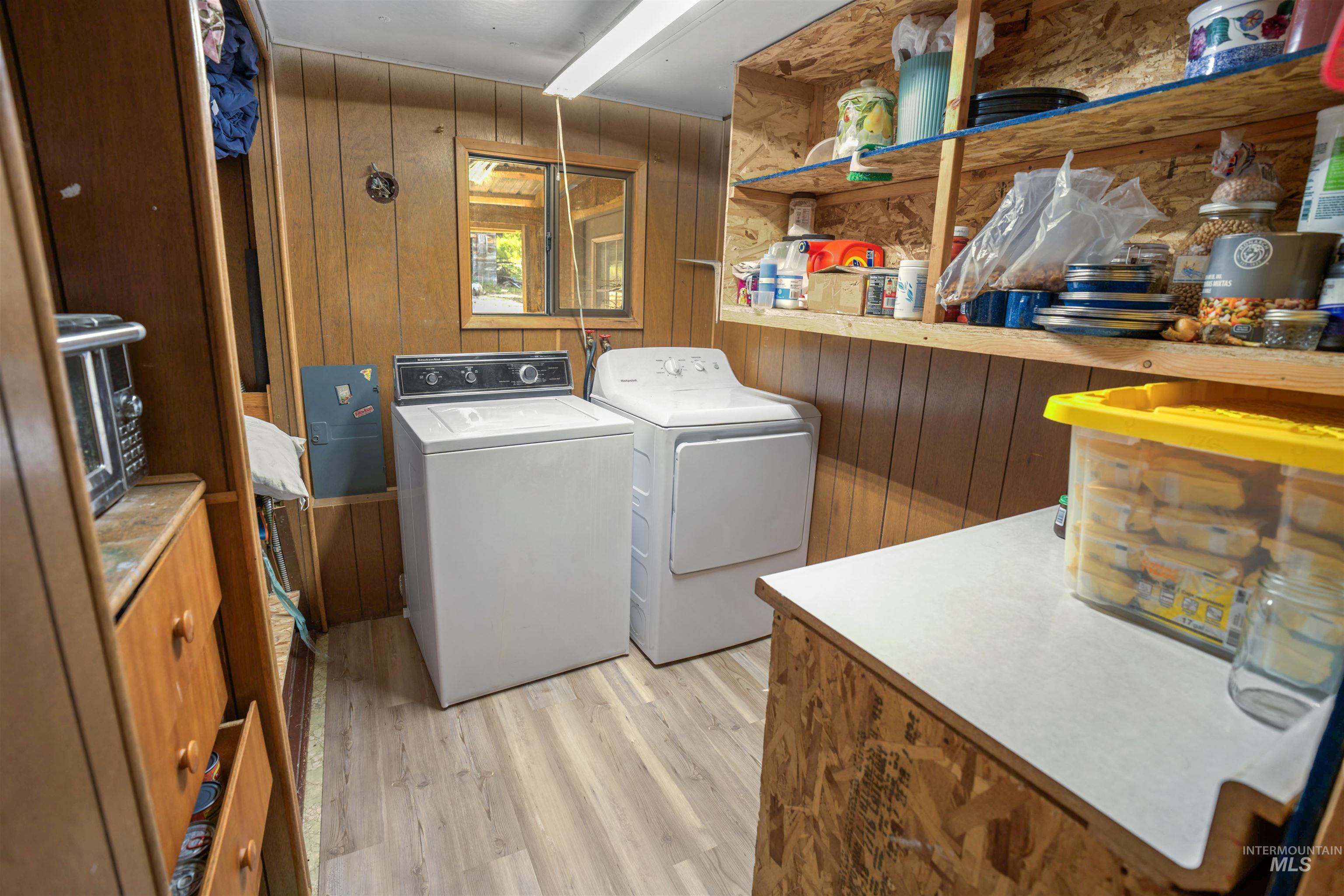 1910 East Mountain Road Anatone, WA 99401 - Photo 23 of 41 Wood-paneled room featuring a window, built-in shelving, wood-finish flooring, and a countertop surface