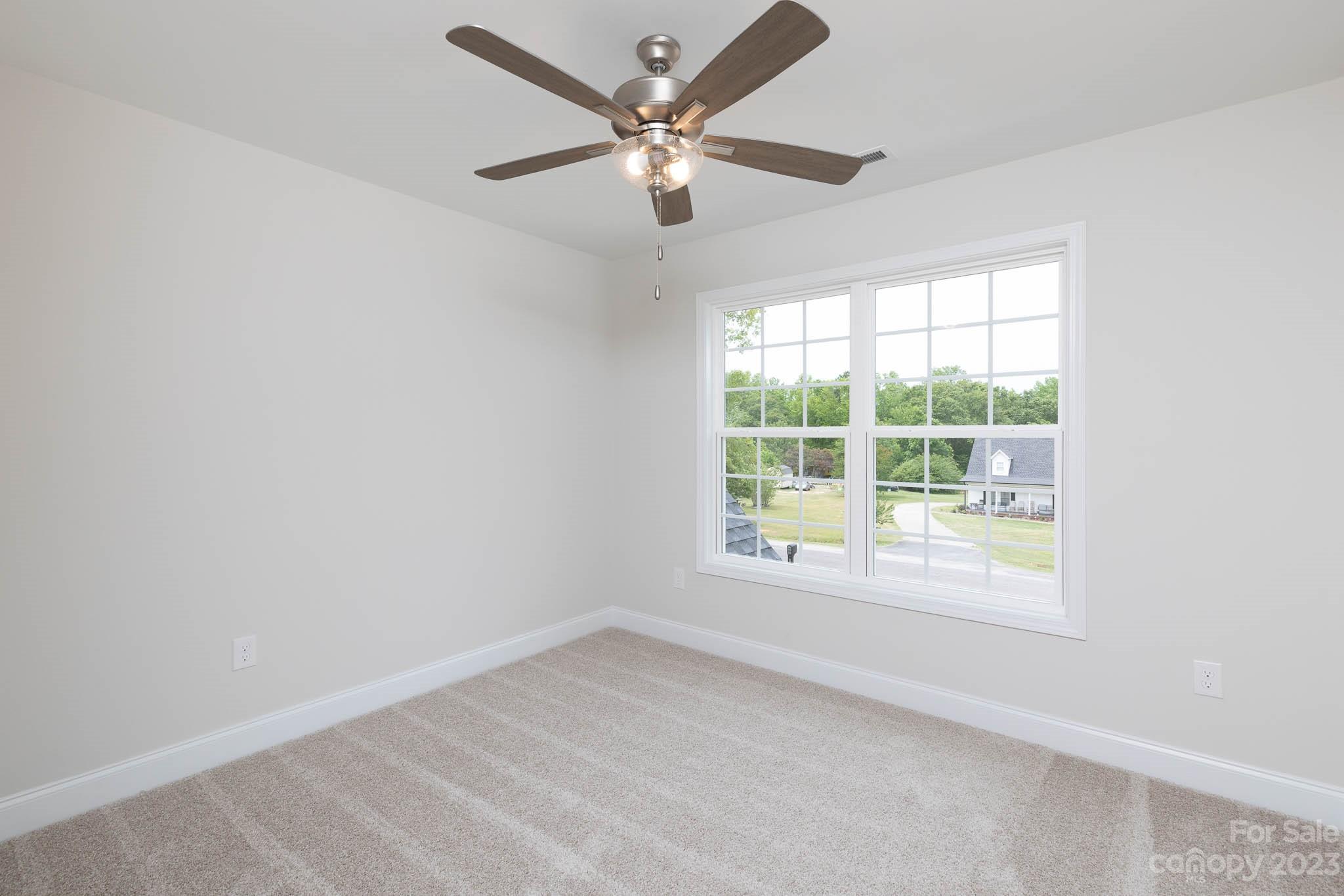 4420 Culp Road Edgemoor, SC 29712 - Photo 16 of 25 an empty room with a window and a fan