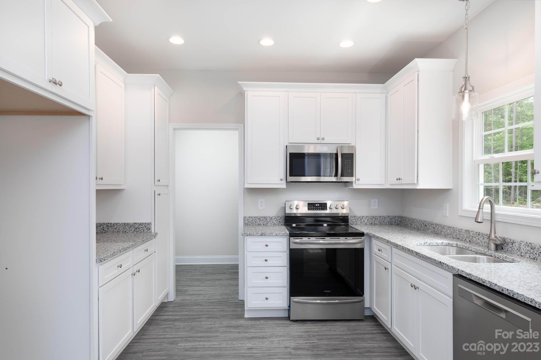 4420 Culp Road Edgemoor, SC 29712 - Photo 4 of 25 a kitchen with stainless steel appliances granite countertop a stove a sink and a refrigerator