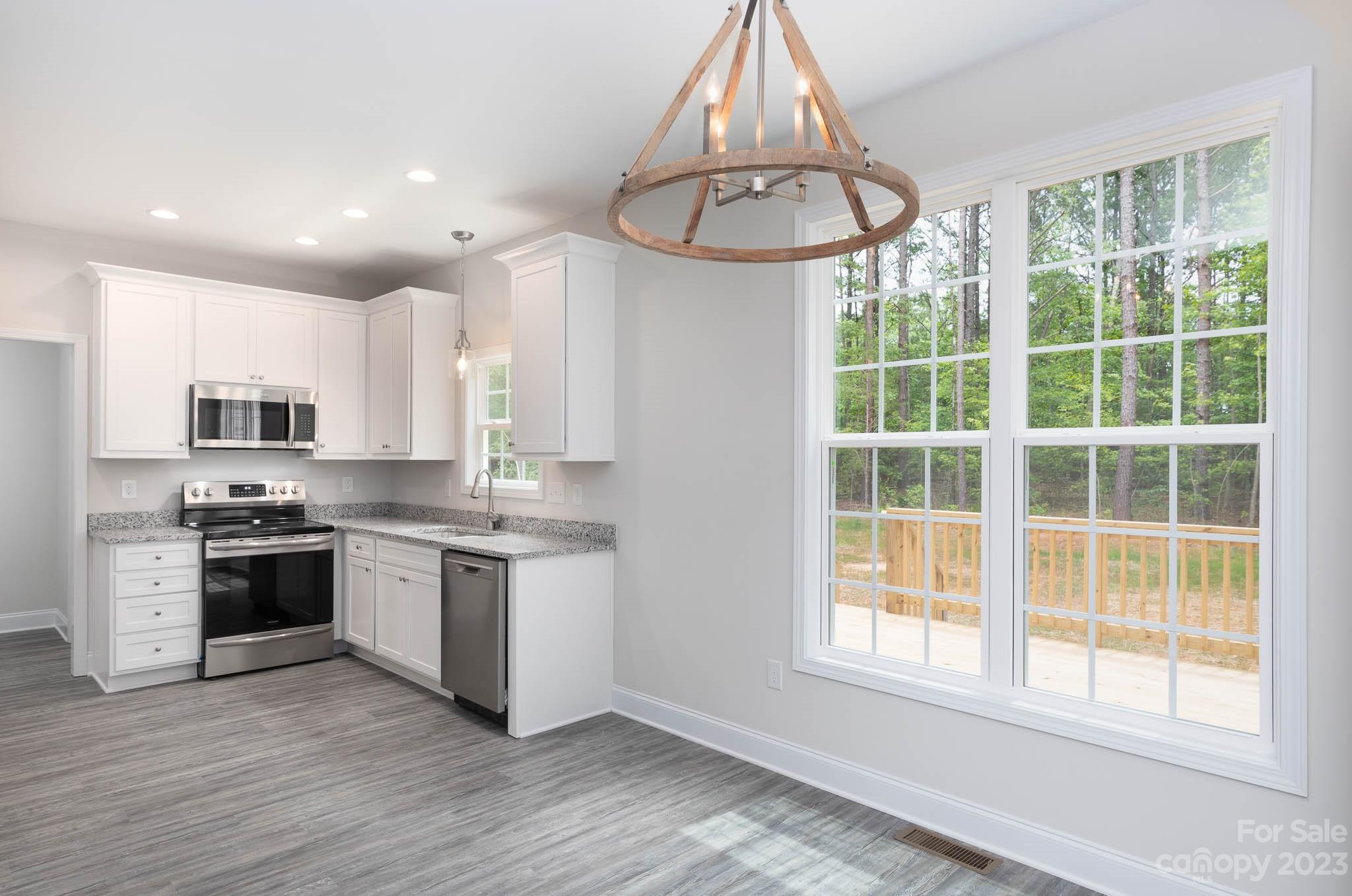 4420 Culp Road Edgemoor, SC 29712 - Photo 5 of 25 a large kitchen with stainless steel appliances granite countertop a stove a sink and a refrigerator