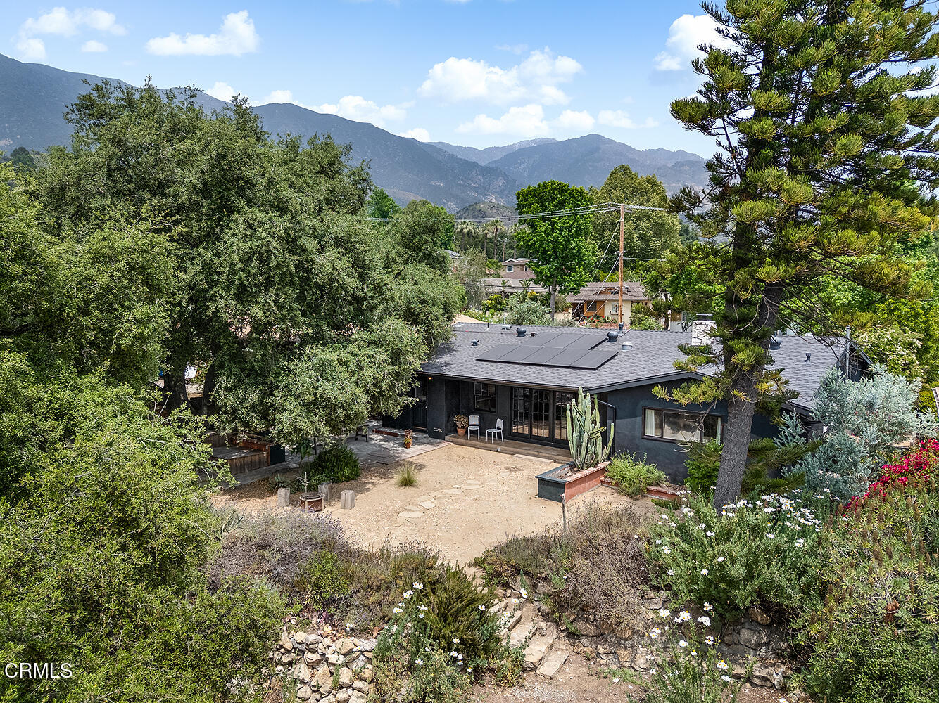 a view of a house with roof deck and sitting area