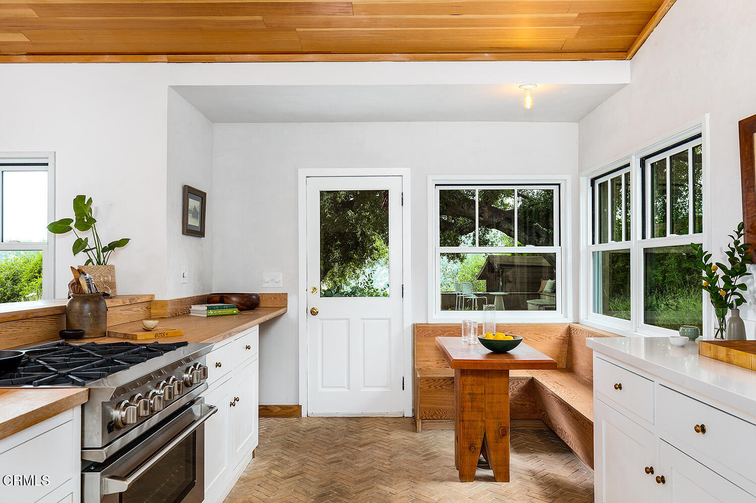 4155 Aralia Road Altadena, CA 91001 - Photo 17 of 40 a kitchen with a stove a sink and a wooden cabinets