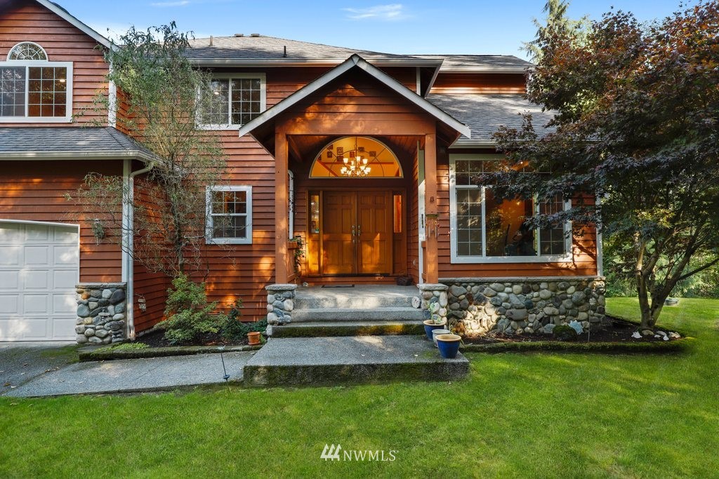10606 Wagner Road Snohomish, WA 98290 - Photo 1 of 40 a front view of a house with a yard