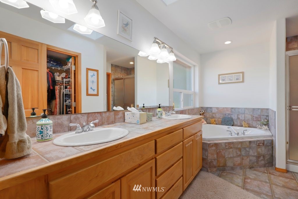 10606 Wagner Road Snohomish, WA 98290 - Photo 23 of 40 a bathroom with a sink double vanity granite and a mirror