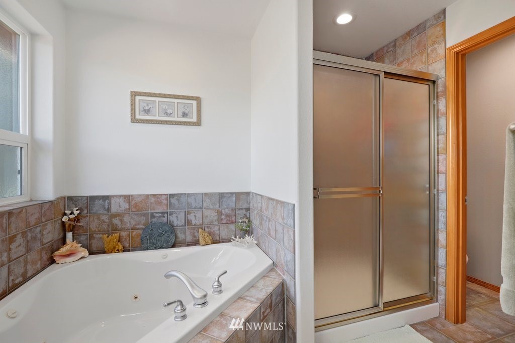 10606 Wagner Road Snohomish, WA 98290 - Photo 24 of 40 a bathroom with a tub and shower