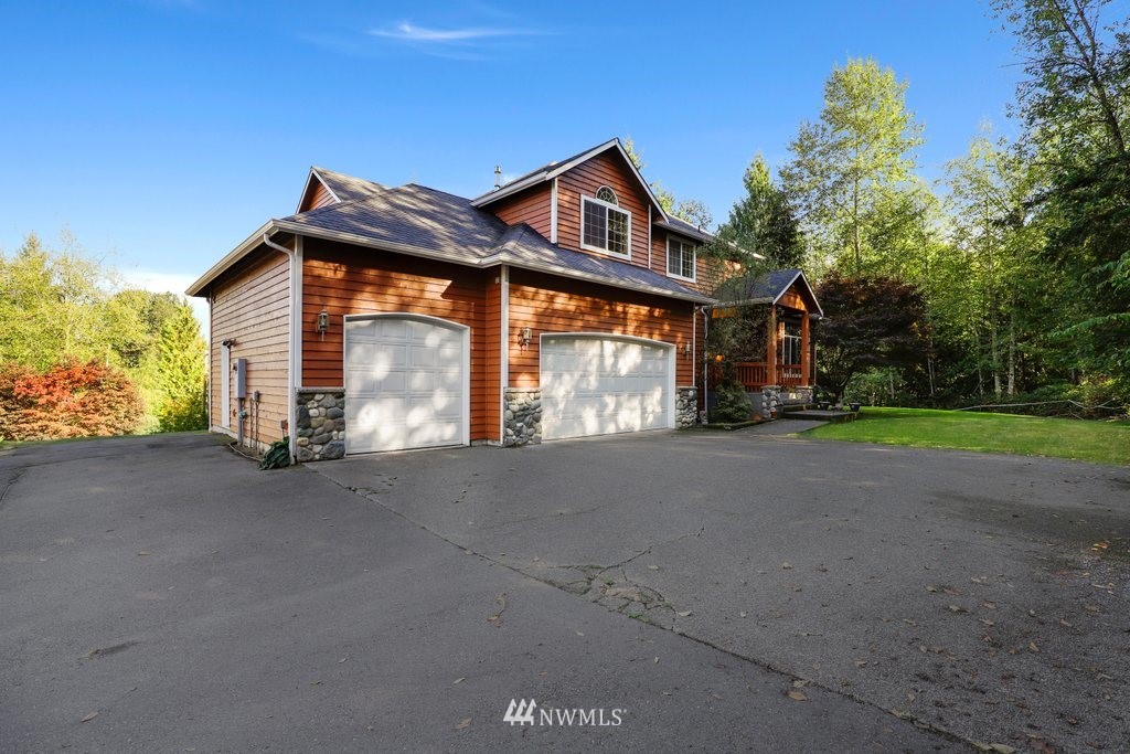 10606 Wagner Road Snohomish, WA 98290 - Photo 36 of 40 a front view of a house with a yard and garage