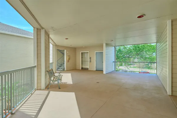 a view of a room with wooden floor and windows