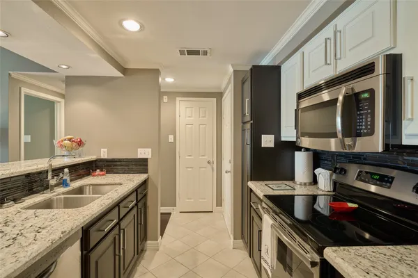 a kitchen with a sink stove and cabinets
