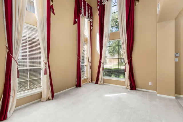 a view of an empty room with windows