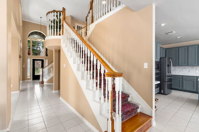 a bedroom with a bed a flat screen tv and a window