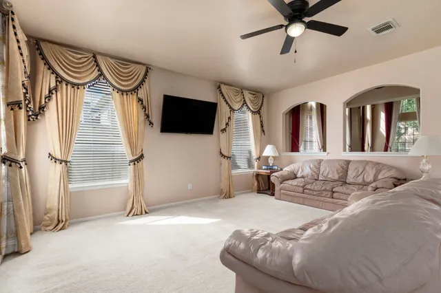 a kitchen with a dining table chairs and refrigerator