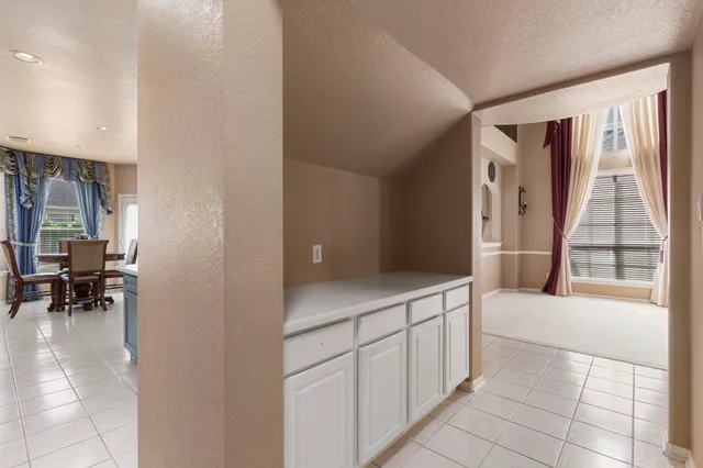 a spacious bedroom with a bed and a chandelier