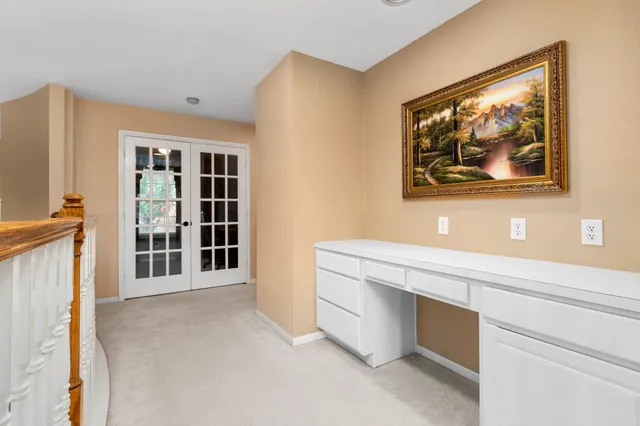 a bedroom with a bed and a mirror