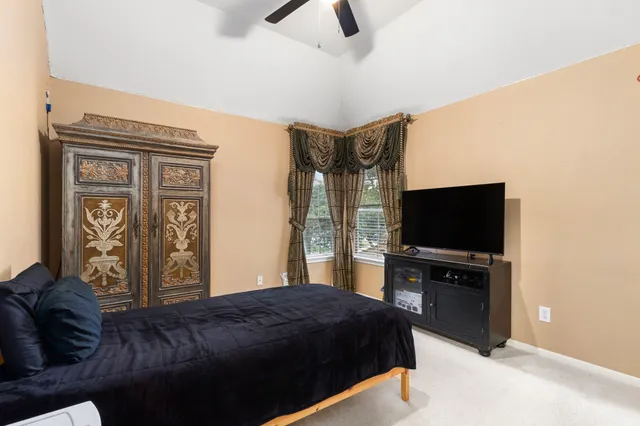 a bed sitting in a bedroom next to a window