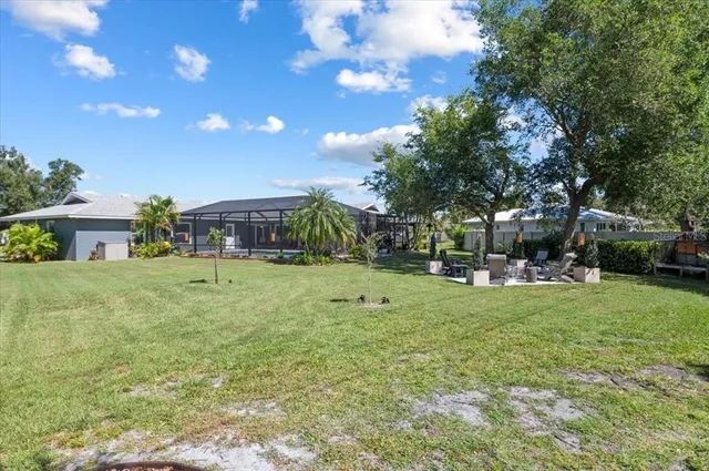 a living room with furniture flat screen tv and a large window