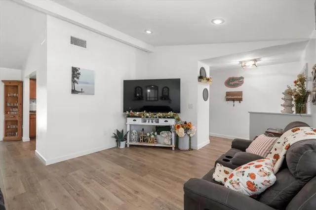 a large kitchen with stainless steel appliances granite countertop a refrigerator a stove top oven a sink and dishwasher