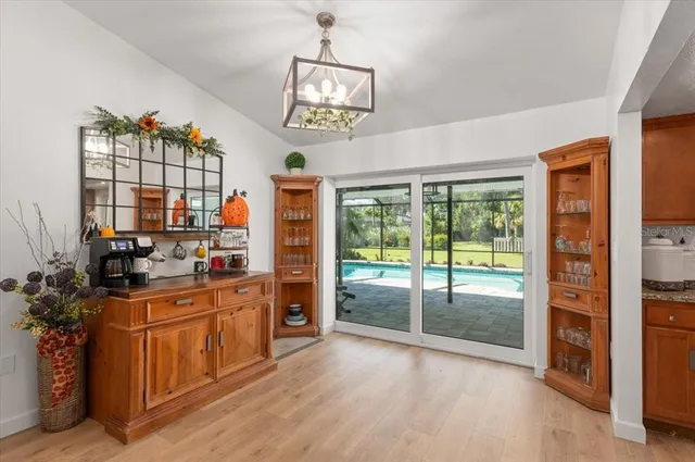 a kitchen with granite countertop stainless steel appliances a sink window and cabinets